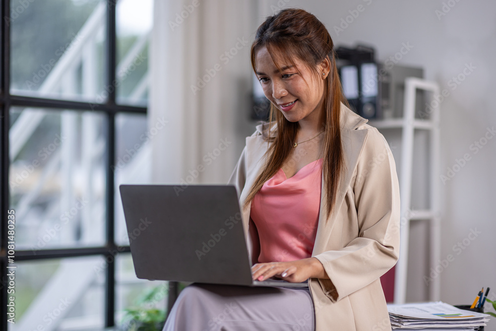 Happy Beautiful asian entrepreneur woman typing on laptop at office work table, looking at camera with toothy smile, posing for professional portrait, enjoying business success, successful job
Happy Beautiful asian entrepreneur woman typing on laptop at office work table, looking at camera with toothy smile, posing for professional portrait, enjoying business success, successful job