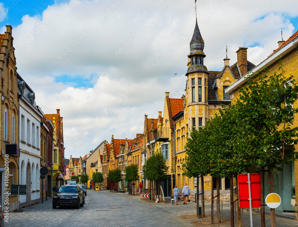 Obraz premium Scenic view of summer cityscape of Diksmuide overlooking typical street with Flemish style townhouses on sunny day, Belgium.
