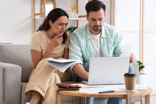 Young couple using laptop t...