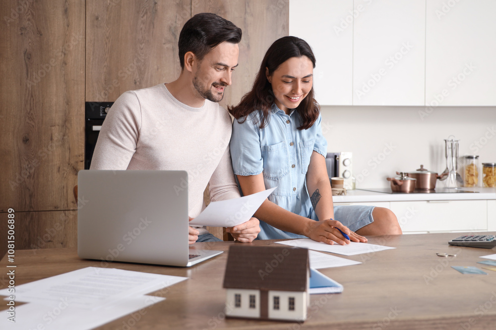 Young couple discussing something and writing down at home. Bankruptcy concept Young couple discussing something and writing down at home. Bankruptcy concept