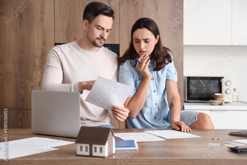 Young couple in debt discus...