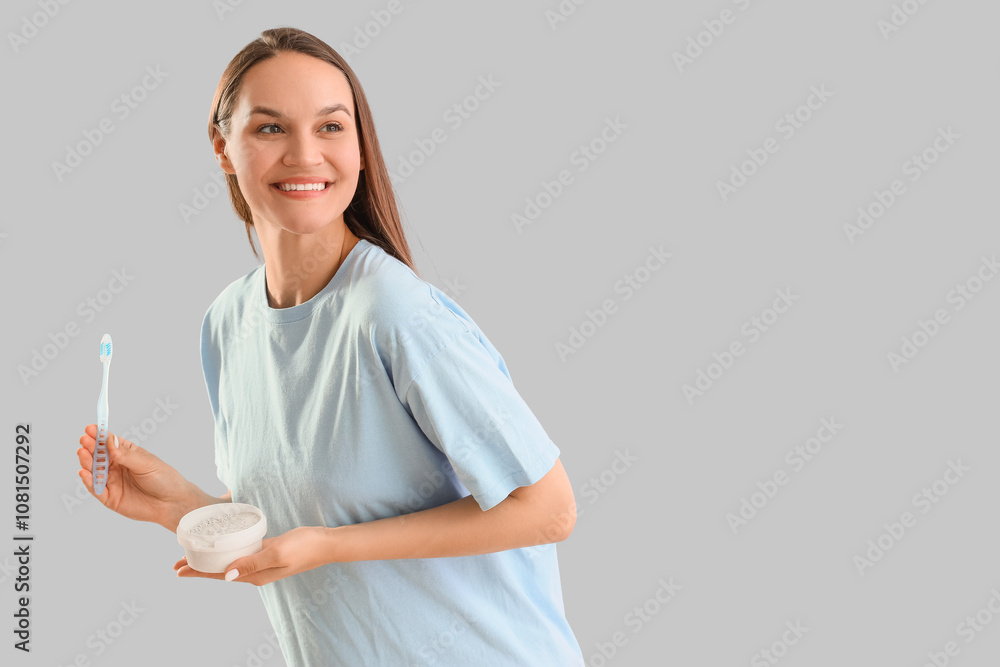 Young woman with tooth powder and brush on light background Young woman with tooth powder and brush on light background