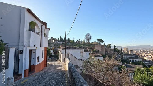 Golden evening light in the picturesque Albaicín in Granada, Spain. Overlooking the skyline while walking along the slopes near San Cristobal Mirador