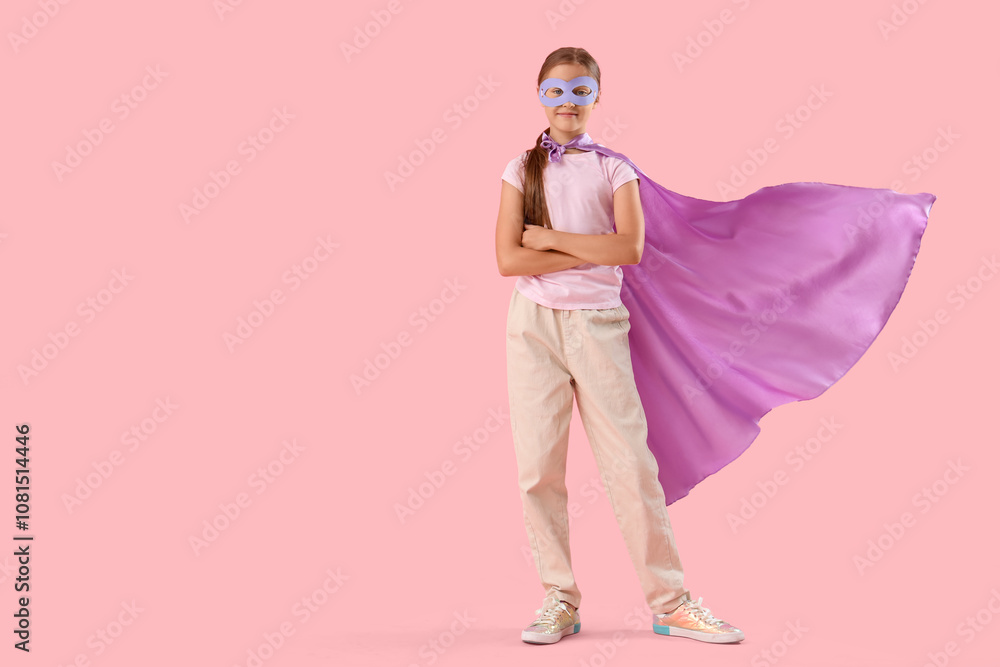 Teenage girl dressed as superhero on pink background Teenage girl dressed as superhero on pink background