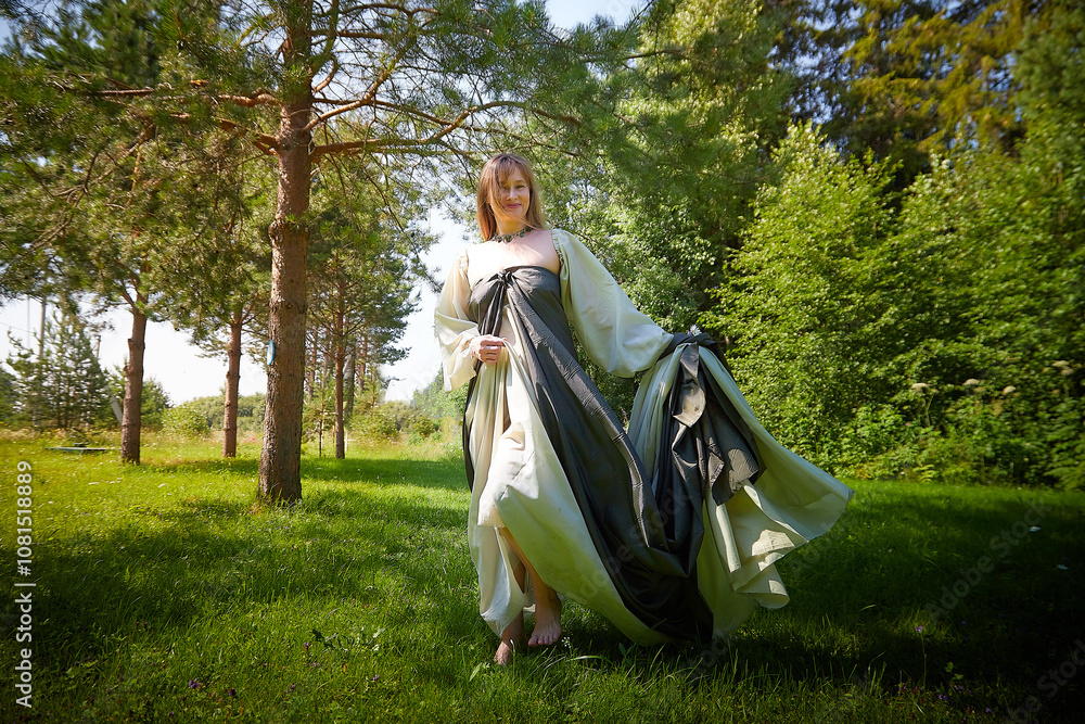 Beautiful dryad or fairy in nature. Pagan spirit of forest. Environmental friendliness and caring for nature. Adult mature woman 40-60 in Photo shoot Beautiful dryad or fairy in nature. Pagan spirit of forest. Environmental friendliness and caring for nature. Adult mature woman 40-60 in Photo shoot