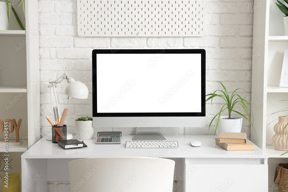 Obraz premium Workplace with computer monitor and plant in office