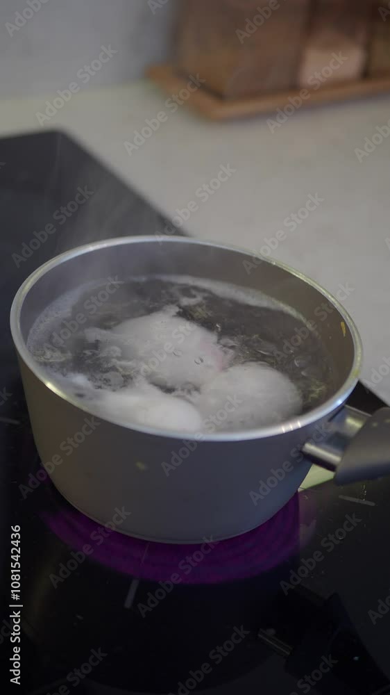 Boiling Eggs in a Durable Stainless Steel Pot on a Stovetop for a Hearty Breakfast Meal to Enjoy Boiling Eggs in a Durable Stainless Steel Pot on a Stovetop for a Hearty Breakfast Meal to Enjoy