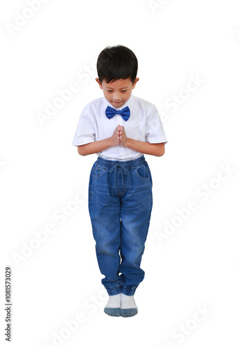 Asian boy kid age 7 years old in neat and nice looking outfit make praying sign while standing isolated on white background. Image full length with Clipping path. photo