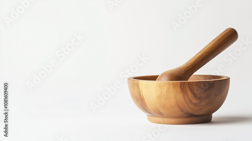 A wooden bowl with a wooden spoon in it