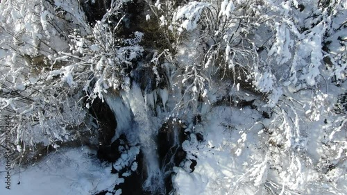 Aerial View of Gostilje Vodopad, Serbia. Natural Cold Water Pool and Waterfall on a Winter Day, Drone Shot photo