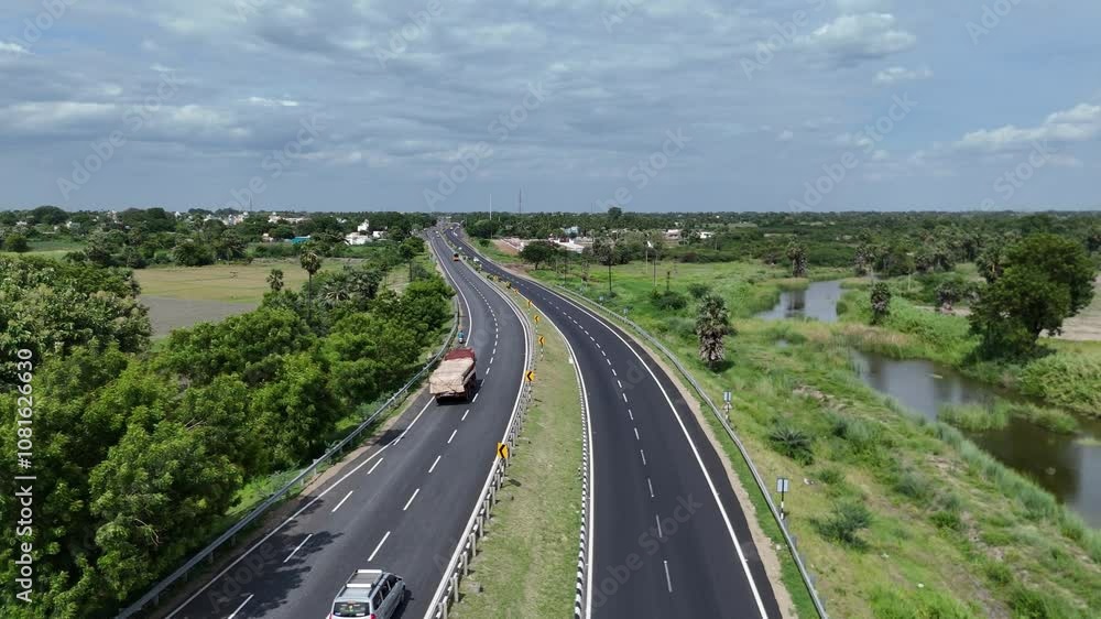 Expansive highway cutting through the countryside in India Expansive highway cutting through the countryside in India