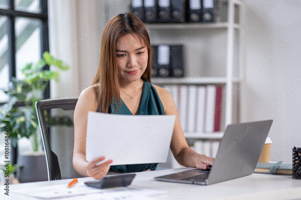 asian business woman working in office checking documents. young businesswoman accounting manager executive or lawyer using laptop reading paper file financial report, tax invoice.
asian business woman working in office checking documents. young businesswoman accounting manager executive or lawyer using laptop reading paper file financial report, tax invoice.