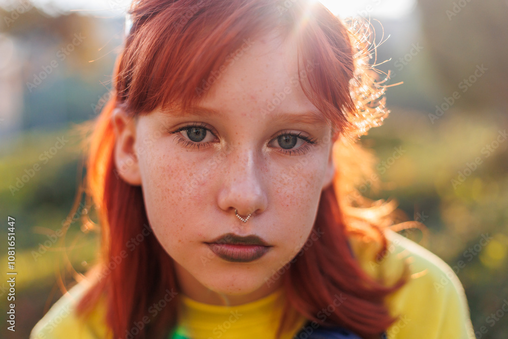 Young beautiful smiling girl with piercing on her face in fashionable clothes. Carefree woman smiling on the street on a sunny day. Young beautiful smiling girl with piercing on her face in fashionable clothes. Carefree woman smiling on the street on a sunny day.