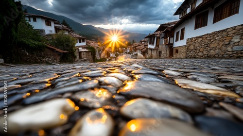Fototapeta Naklejka Na Ścianę i Meble -  A cobblestone street in a small town under a cloudy sky
