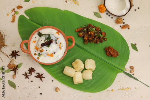 Homemade Curd Rice with pomegranate, cilantro, ginger on a black background. Top view. Traditional Indian South cuisine photo