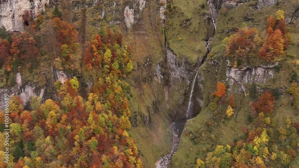 Vibrant autumn foliage near waterfall in Klöntal Valley, Glarus, Switzerland Vibrant autumn foliage near waterfall in Klöntal Valley, Glarus, Switzerland
