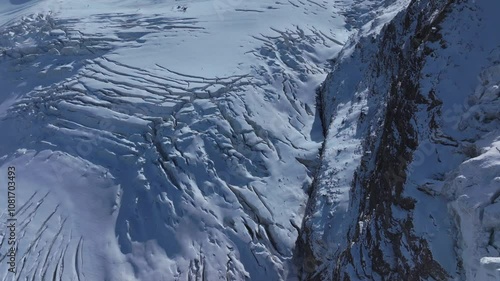 Saastal Saas Fee Ski Resort aerial drone Switzerland morning afternoon ice glacier autumn fresh snow Mount Swiss Alps Alphabel clear skies cold dramatic winter scenery mountain peaks clouds upwards photo