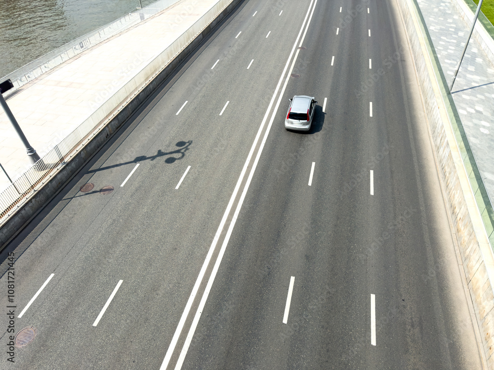 A car is driving down a highway with a white line separating the lanes A car is driving down a highway with a white line separating the lanes