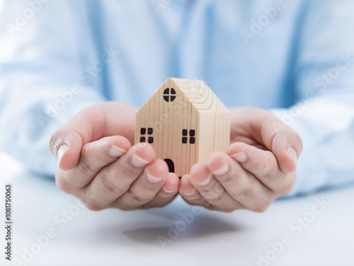Obraz na płótnie Homeownership goals personal finance wooden house model indoor setting close-up perspective concept of security and stability in real estate w salonie