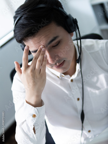 Frustration during a customer service call office setting emotional expression indoor environment close-up view stress management strategies