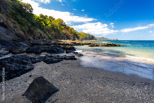 Long exposure, pacific ocean waves on rock in Playa Ocotal, El Coco Costa Rica photo