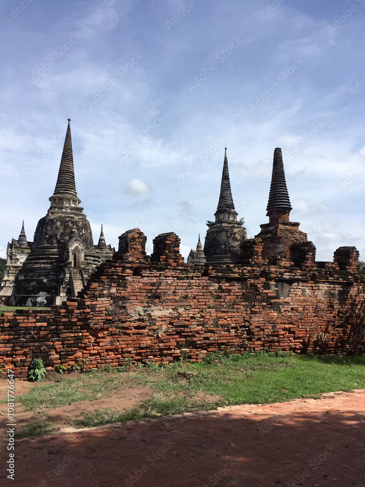 Fototapeta premium Ancient Brick Wall and Stupas in Ayutthaya, Thailand.