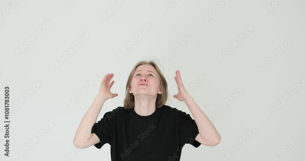 Woman reacts with excitement and screams into top of hands on a white background Woman reacts with excitement and screams into top of hands on a white background