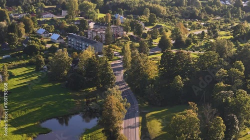 Aerial Rotation Over The Historic Town Of Nitaure Parish, Cesis, Vidzeme, Latvia. Multi-Story Buildings, Homes, And Cottages Surrounded By Nature Parks. photo