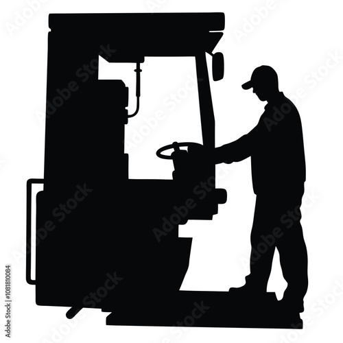 A man is working on a machine. The machine is black and has a large wheel. The man is wearing a hat