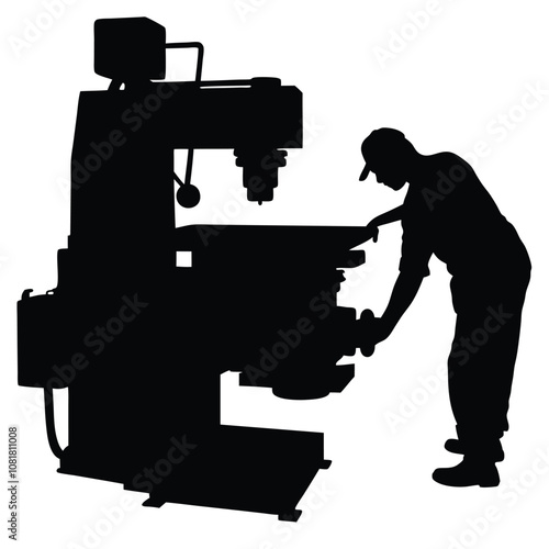 A man is working on a machine. The machine is black and has a large wheel. The man is wearing a hat