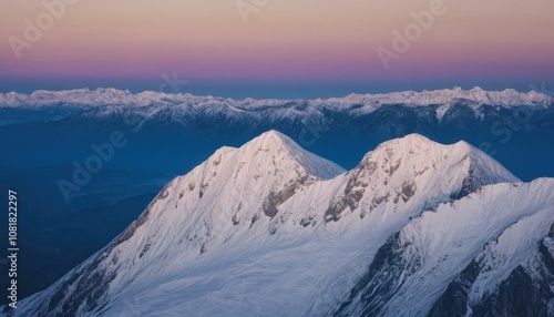 Snow-covered mountain peaks at dawn