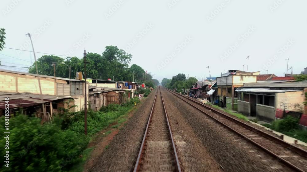 The train travels along the train tracks to the next station The train travels along the train tracks to the next station