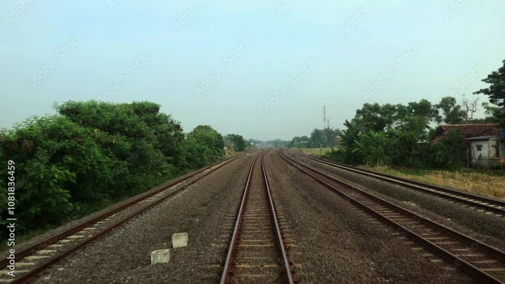The train travels along the train tracks to the next station The train travels along the train tracks to the next station