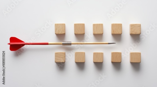 A minimalist photo of a red dart and wooden blocks, arranged symmetrically on a white background, creating a balanced and visually appealing concept photo