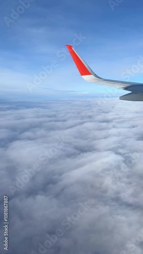 air plan wing, blue sky and clouds, view from windows. Vertical video