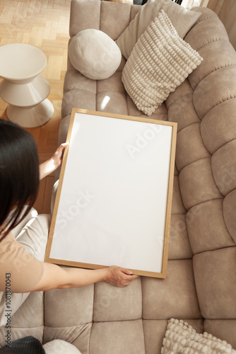 50x70 cm Frame Mockup held by a person in a modern apartment photo