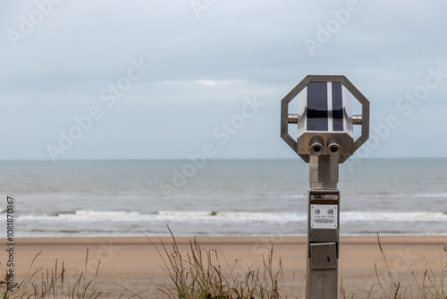 Beach Telescope Facing the Ocean for Scenic Viewing: Coastal Observation Point on a Cloudy Day