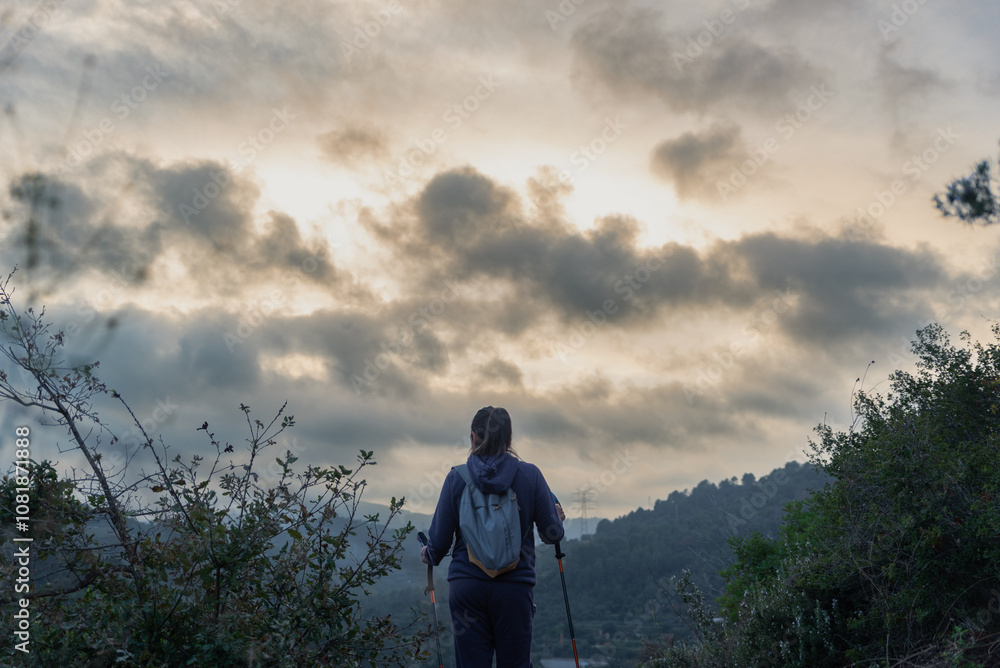 Hiker surrounded by trees, nature and a beautiful sky at sunset. Hiker surrounded by trees, nature and a beautiful sky at sunset.