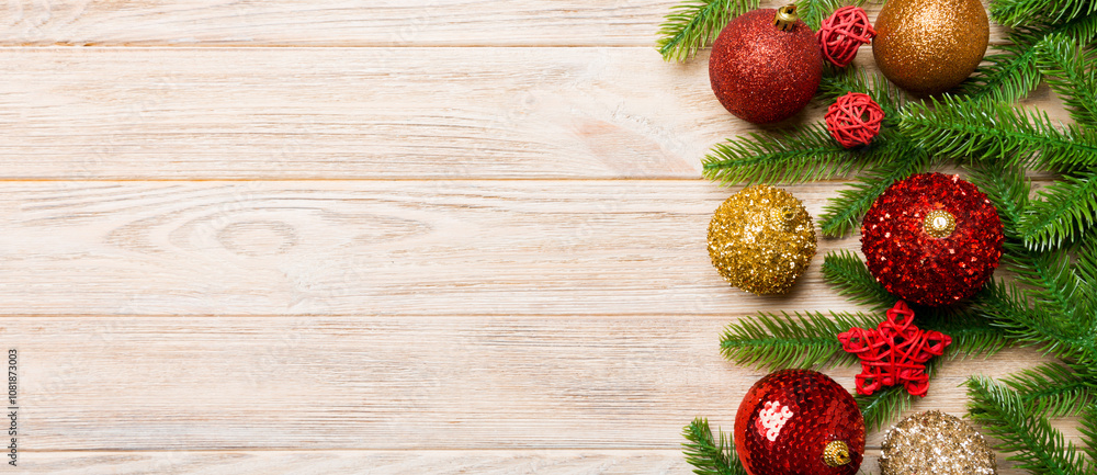 Christmas composition made of fir tree, balls and different decorations on wooden background. Top view of New Year Advent concept with empty space for your design Christmas composition made of fir tree, balls and different decorations on wooden background. Top view of New Year Advent concept with empty space for your design