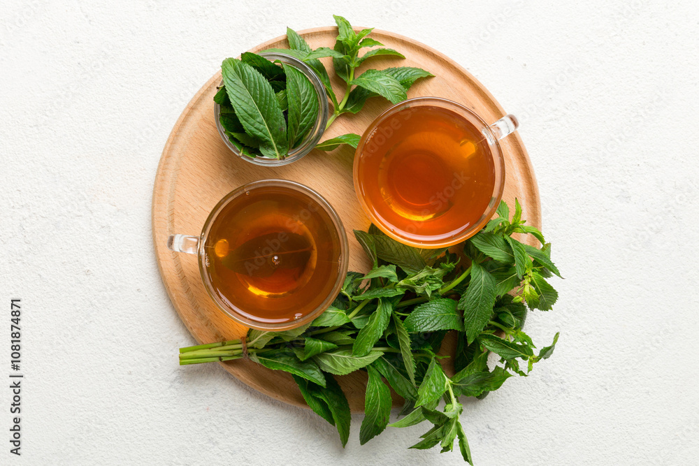 Cup of mint tea on table background. Green tea with fresh mint top view with copy space Cup of mint tea on table background. Green tea with fresh mint top view with copy space