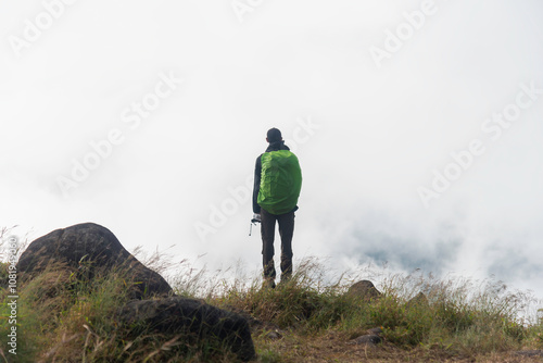 Traveler sightseeing the beautiful scenery of nature and mist during time the sunrise