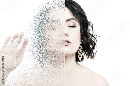 Portrait of a woman with dark hair, dressed in a white shirt, done in a high key.