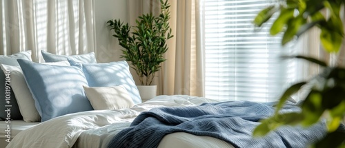 The cozy bedroom showcases a neatly made bed with plush pillows and blankets, surrounded by bright sunlight filtering through sheer curtains and plants