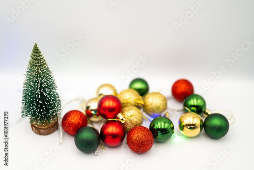 Capture the magic of the holidays with this captivating image of colorful Christmas ornaments nestled amongst twinkling fairy lights. 