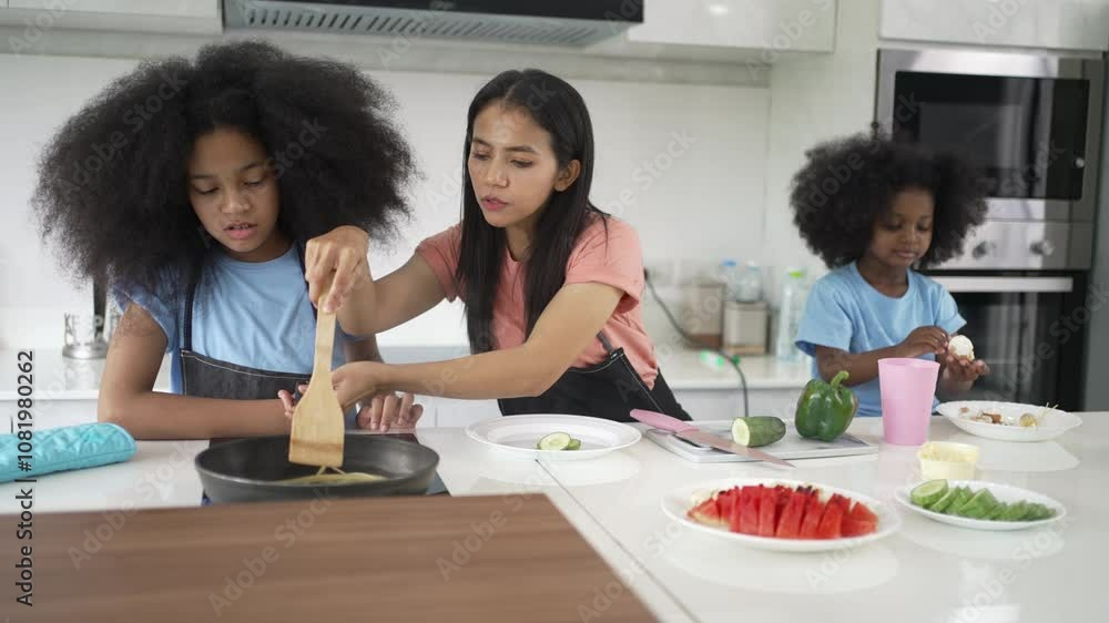 Mother and daughters are cooking food in the kitchen. Lifestyle, weekend activity.