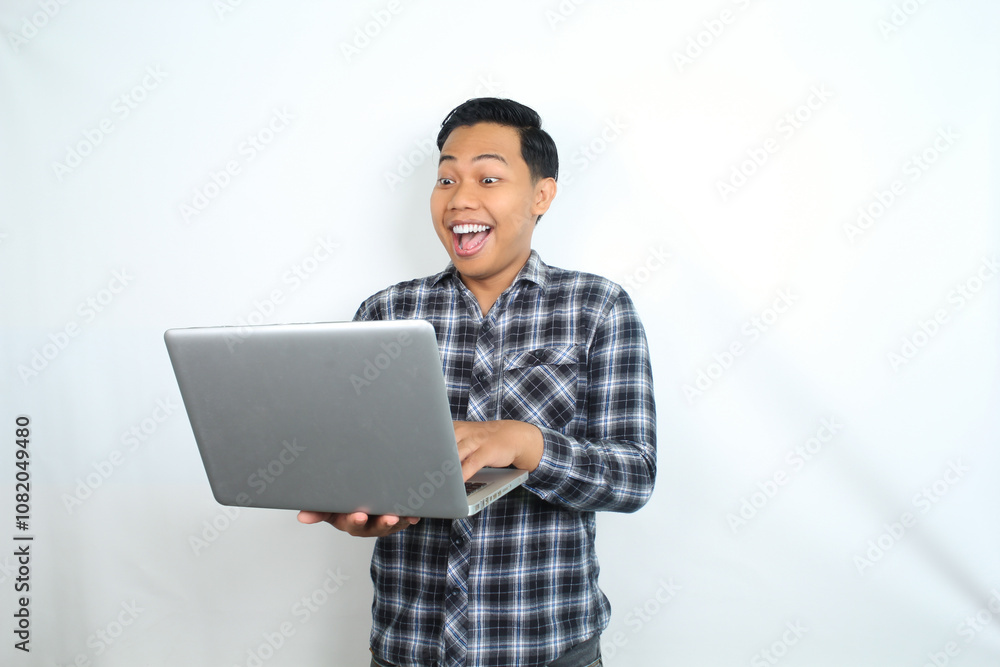 surprised and shocked asian man using laptop isolated on white wearing casual shirt surprised and shocked asian man using laptop isolated on white wearing casual shirt
