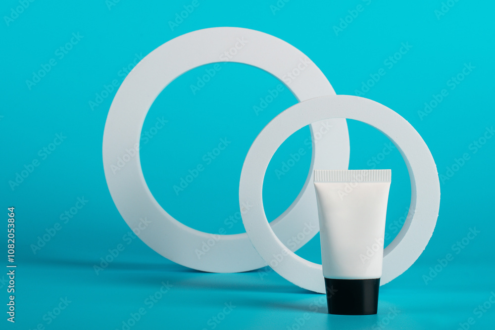 Plastic white tube for cream or lotion. Skin care or sunscreen cosmetic on orange background. Plastic white tube for cream or lotion. Skin care or sunscreen cosmetic on orange background.