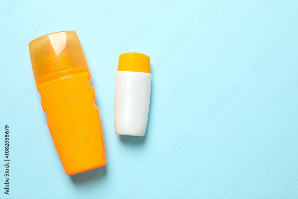 Top view of SPF skin care bottles on colored background Top view of SPF skin care bottles on colored background