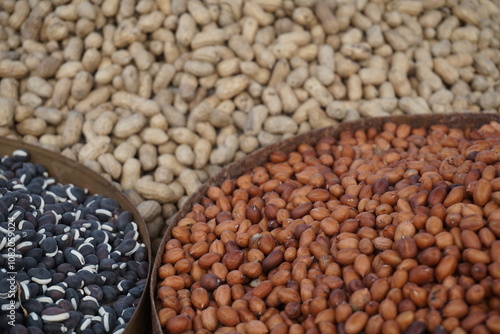 Roasted peanut and bean are being sold on a food cart, A heap of organically produce bean and peanut, Mixed peanuts and bean are selling by a street vendor