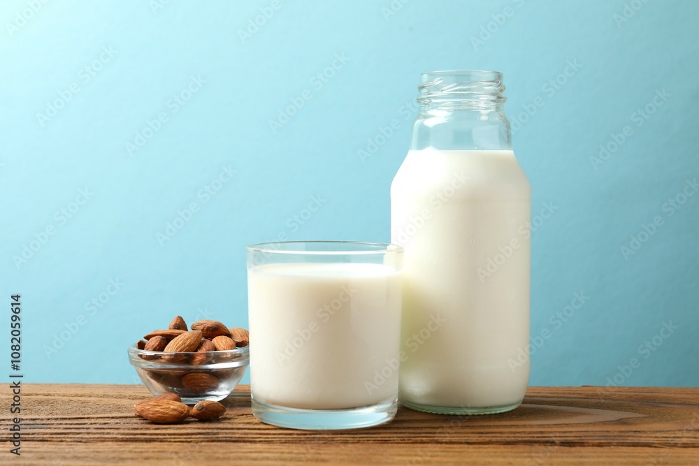 Glass of almond milk with bottle on the table Glass of almond milk with bottle on the table